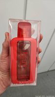 Front view of sealed FCUK Forever Intense Her perfume bottle in red packaging held in hand.