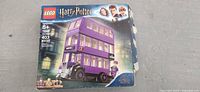Front of the LEGO box showing the Harry Potter Knight Bus, set number 75957, recommended ages 8+, 403 pieces, box open and worn.