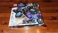 Front of the Lego box showing the assembled Suri's Sunbird vehicle, minifigures, Lego and Marvel branding, and set number 76211