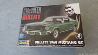 Front of the model kit box showing image of green 1968 Mustang GT and Steve McQueen from Bullitt movie.