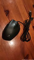 Top view of black wired Logitech gaming mouse with visible braided USB cable.