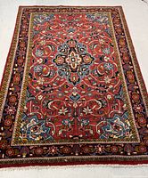Full view of hand knotted Persian Mahal rug on a floor