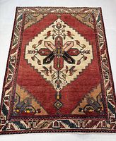 Full view of hand knotted Sarab rug showing central decorative medallion and border