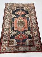 Full top-down view of rectangular rug showing entire medallion design and border