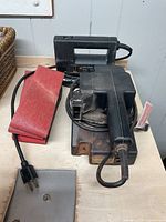 Belt sander, sanding belt, and jig saw displayed showing overall condition and included items.