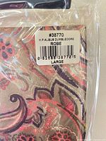 Barcode label showing SKU 38770 and size large on package corner