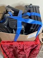 Box of black plastic aquarium filter housings strapped with blue tape