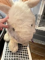 Front view of large white plush bunny with pink-lined ears