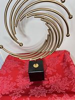 Front view showing full spiral design and black cube base