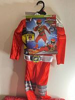 Front view of packaged toddler Red Ranger costume showing jumpsuit, belt and mask