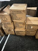 Stack of eight sealed Encore cartons