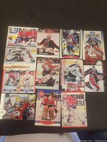 Top view photo showing 12 assorted Patrick Roy hockey cards arranged in three rows, different team poses with Canadiens and Avalanche uniforms visible.