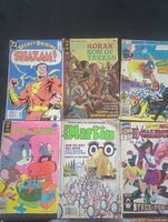 Photo showing six comic book covers: Shazam! #3, Korak Son of Tarzan #11, Team America, Tom and Jerry #37, Don Martin, Excalibur.