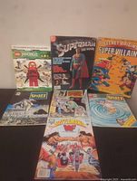 Overview of all 7 items showing the comics, magazines, and sticker book