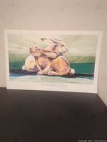 Full image of signed lithograph print titled "Two Hares" by Barry Barnett depicting two brown hares resting with a green background.
