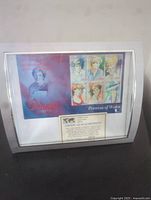 Framed collector's set of six Princess Diana stamps with certificate of authenticity displayed on a surface, showing full view of frame and collector's sheet.