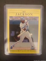 Front photo of 1991 Bo Jackson Fleer baseball card in protective sleeve and top loader showing player batting in Royals uniform.