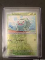 Front view of the Bulbasaur Pokémon card showing the artwork, HP 70, and attack details.