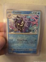 Front view of Cloyster #91 Pokémon card from Scarlet & Violet Blooming Waters set in protective case showing holographic features and card details.
