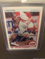 Front side of Patrick Roy Upper Deck hockey card featuring Roy in white goalie gear with number 33 crouched in net.