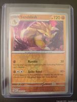 Front view of Sandslash Pokémon card number 28 in protective top loader showing attacks, HP, and artwork.