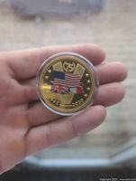 Photo of obverse side showing US, British, and French flags with 75th anniversary marking