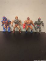 Four He-Man Masters of the Universe figures side by side
