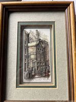 Frontal view of the complete 3D layered paper artwork inside a 5x7 wooden frame showing the full street and building facade scene.