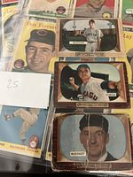 Top side view of four 1950s baseball cards including Don Ferrare, Frank Sullivan, Harry Dorish, and W.F. McKinley cards laid out on table.