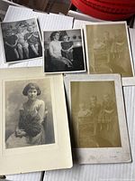 Five vintage 1900s photographs laid out, showing children and adult portraits, some mounted on cardstock