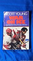 Front cover of 'War on Ice: Canada in International Hockey' showing hockey players in action, with red and white uniforms and title text.