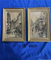 Two matching framed Paris street scene paintings sized 11 x 16 inches each on blue background