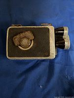 Side view of the camera showing the textured black body and focusing knob.