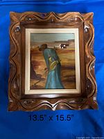Full view of the framed oil painting showing a lone figure in a field, the frame is a decorative carved wood style. Dimensions shown below the frame: 13.5" x 15.5".