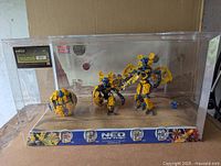 Full view of the sealed store display diorama featuring multiple Mega Bloks Neo Shifter robot figures inside a clear plastic case with branded base.