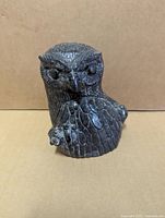 Front view of owl with owlets soapstone sculpture showing detailed carving and texture.