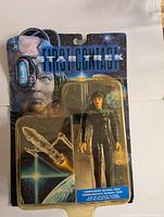 Photo of original unopened 1996 Star Trek First Contact Commander Deanna Troi Playmates action figure in blister card packaging showing yellowed blister and bent card.