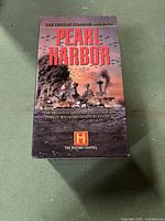 Front cover of the boxed set titled 'Pearl Harbor' with artwork depicting the attack on Pearl Harbor with battleships and airplanes against a smoky sky.