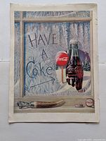 Full view of vintage Coca-Cola 'Have a Coke' magazine advertisement with frosted window and bottles.