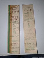 Photo of packaging fronts for Allcocks Model Perfect and Tested Hooks to Single Gut cards with printed text and branding details.