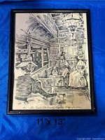 Framed monochrome print depicting interior of an old-fashioned train car with passengers seated, signed or labeled 'Pucci'