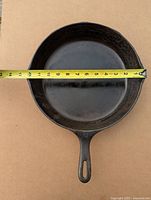 Top view of skillet with tape measure showing approx 10-inch interior diameter.
