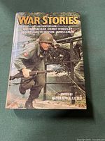 Front cover of War Stories hardcover book showing soldier in wartime uniform near barbed wire with authors and editor name.
