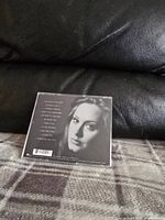Back cover photo of the CD case showing tracklist and black and white image of Adele