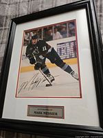 Front of framed photo showing Mark Messier in hockey uniform and signature