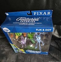 Boxed set of Flik and Dot figures from Pixar's A Bug's Life with accessories inside clear packaging.