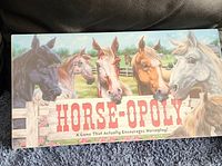 Front of the sealed HORSE-OPOLY board game box showing horse illustrations and game title.