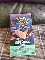 Paper sleeve showing Gremlins movie artwork with a Gremlin character and text credits