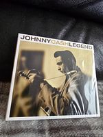 Front cover photo showing Johnny Cash playing guitar, title 'Johnny Cash Legend'