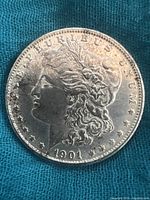 Obverse (front) side of 1901 Morgan silver dollar coin showing Lady Liberty profile and date 1901.